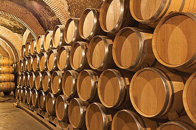 Wine cave with oak barrels presumably filled with Garnet wine